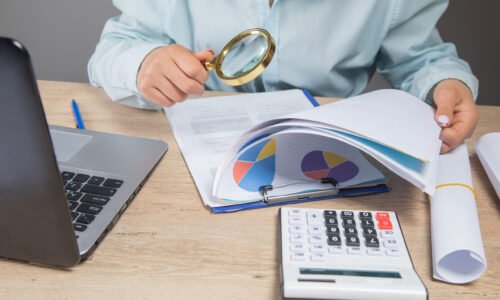 businesswoman counts examines data in the office