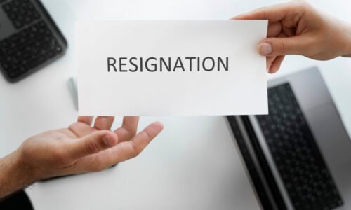 employee-holding-resignation-letter-top-view