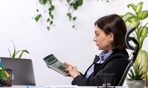 front-view-beautiful-young-businesswoman-black-jacket-blue-shirt-working-with-calculator-front-table-business-job-office